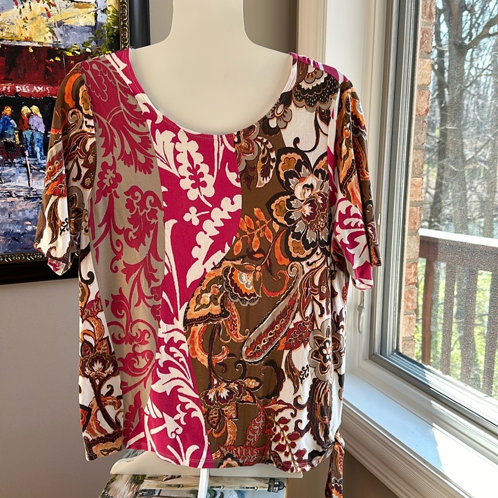 Chico’s Top multi colored with loop tie on bottom. Size 2 (Large)